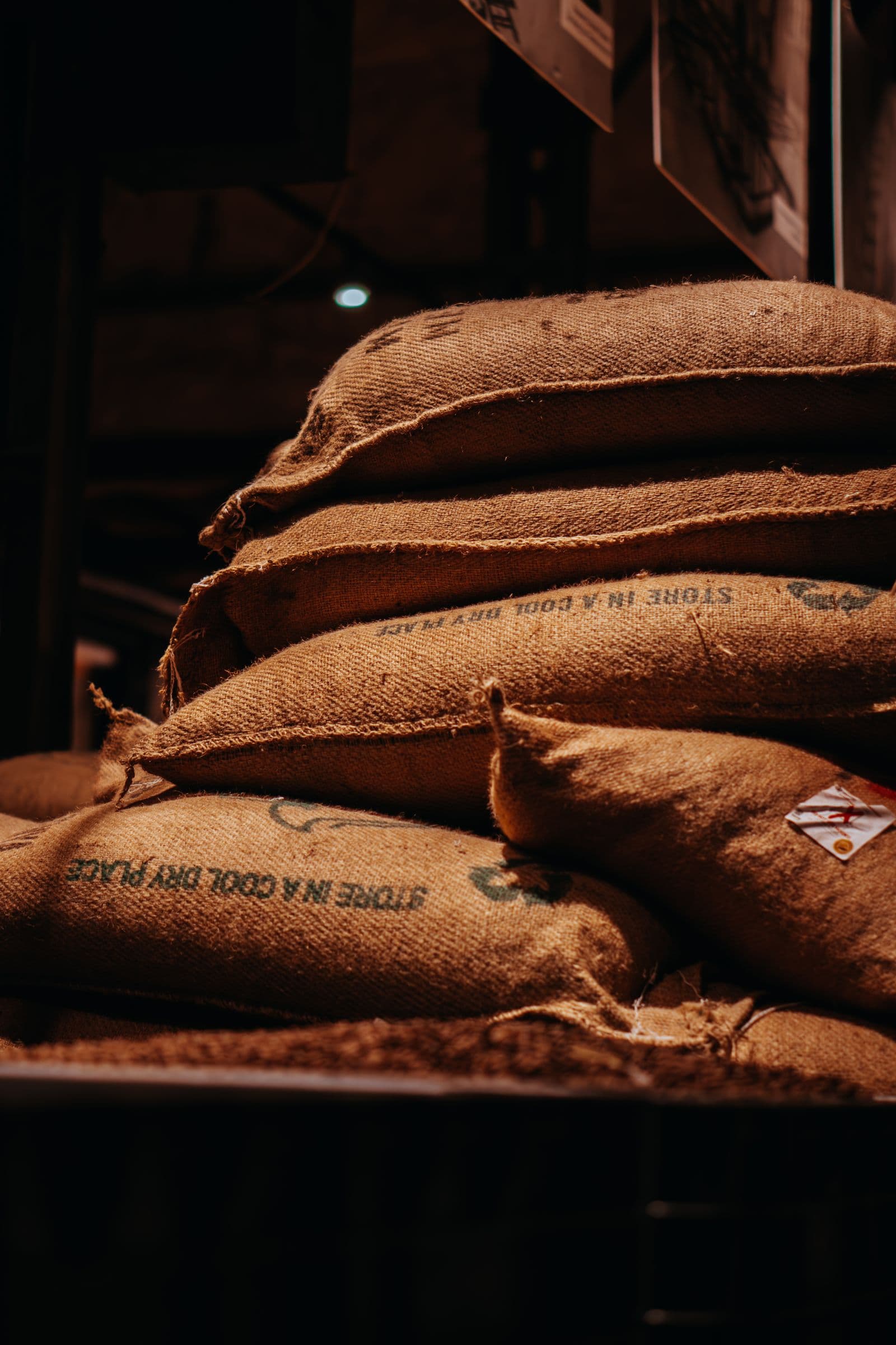 Stacked jute sacks in a store, stencilled with handling instructions